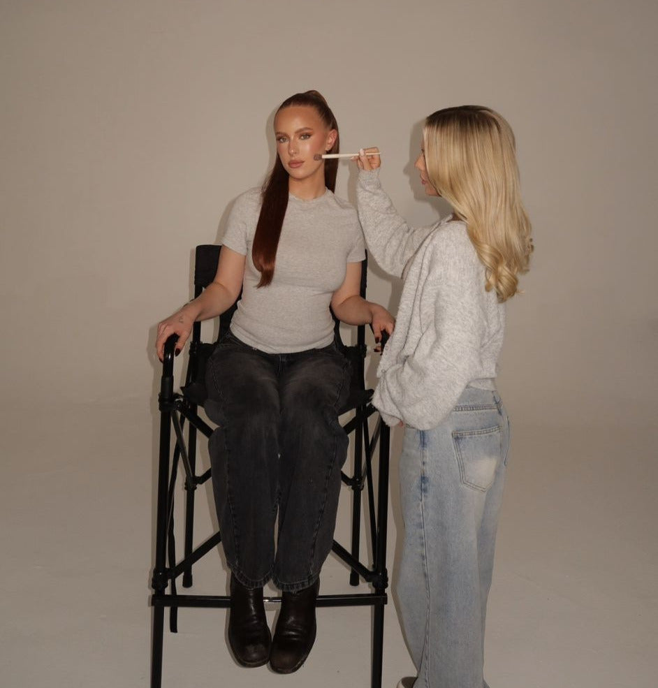 Ellie, MELY founder, doing makeup on set